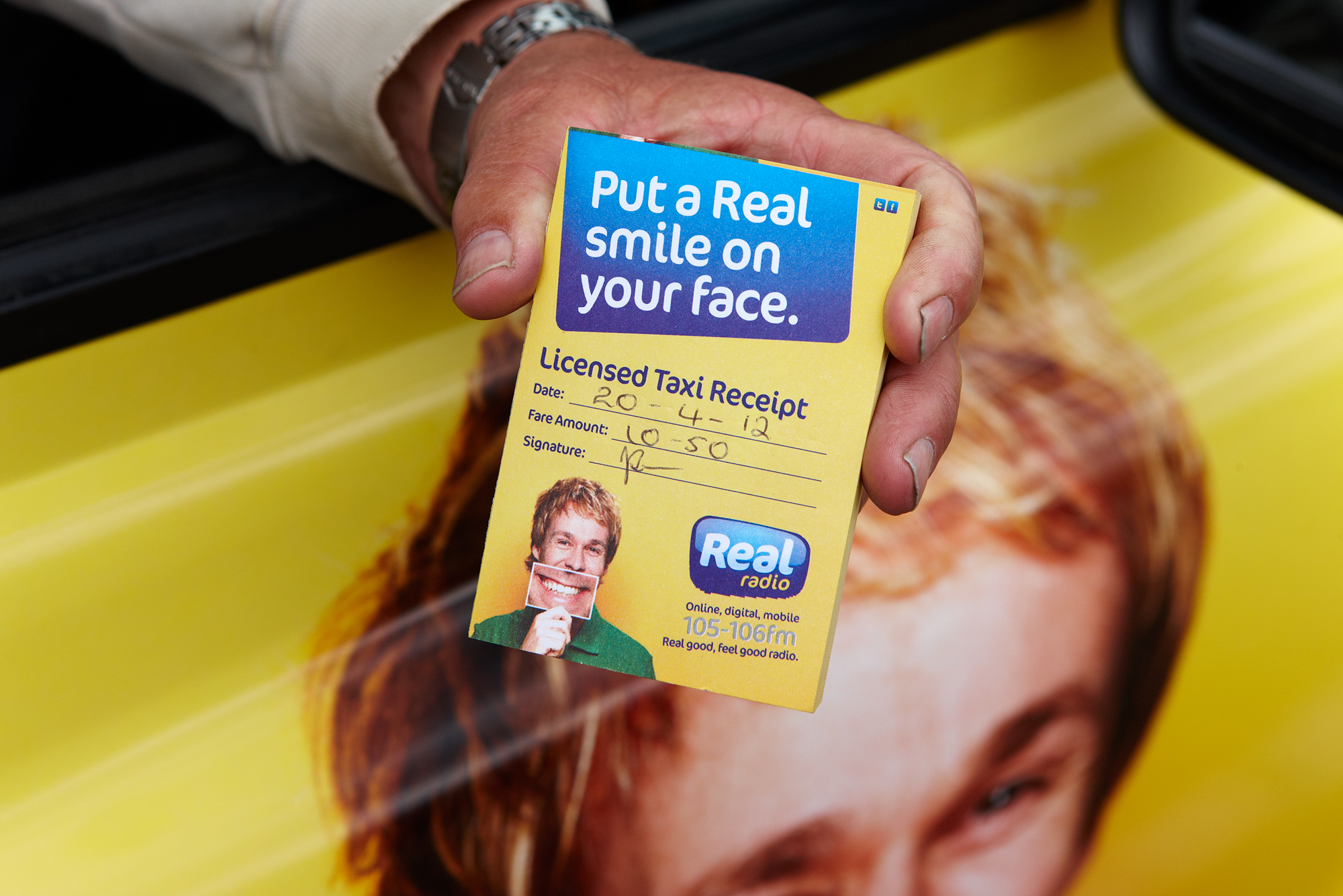 2012 Ubiquitous taxi advertising campaign for Real Radio - Put a Real Smile on your Face